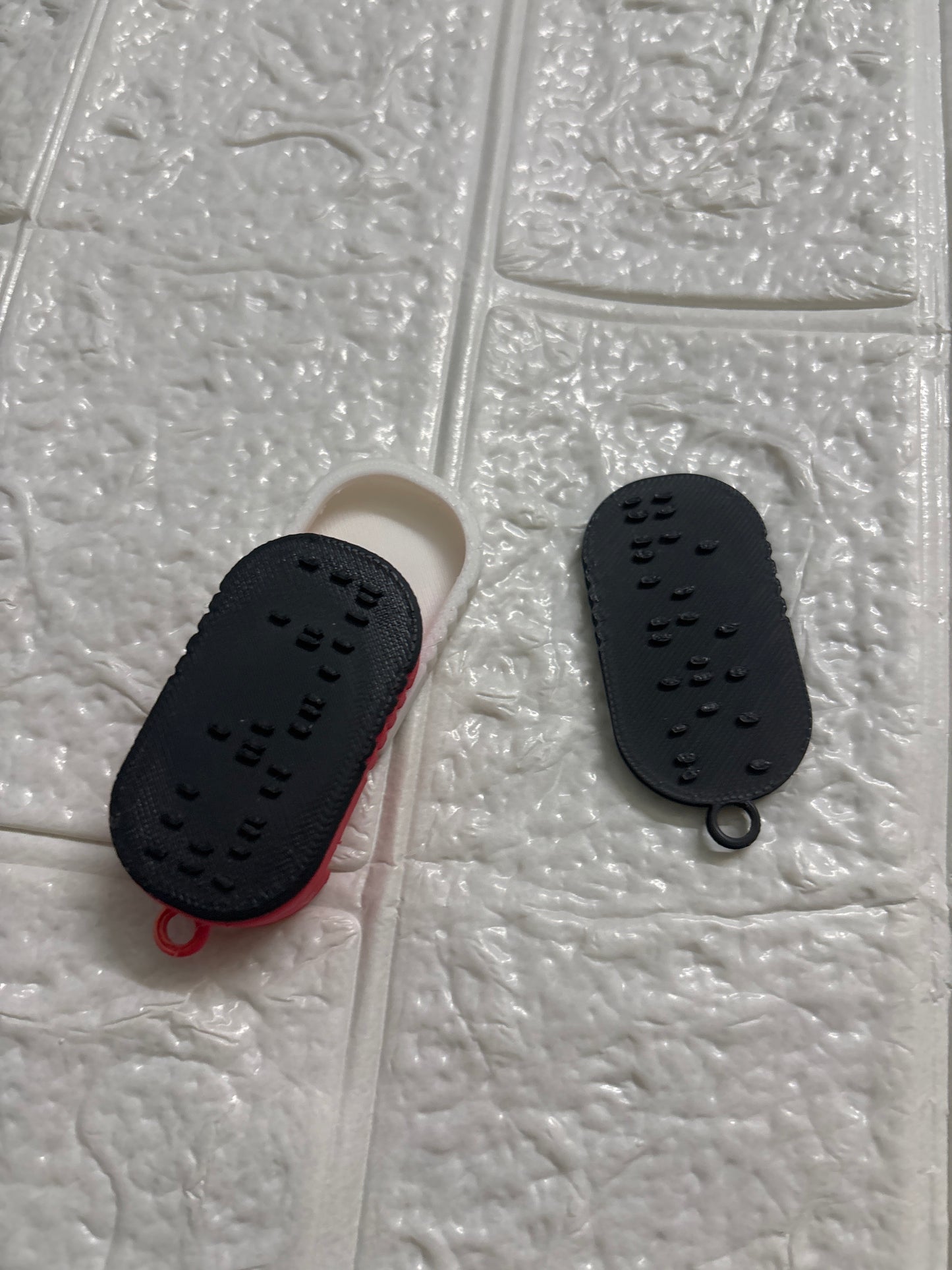 A 3D-printed Braille keychain with a built-in NFC chip — designed for universal accessibility.