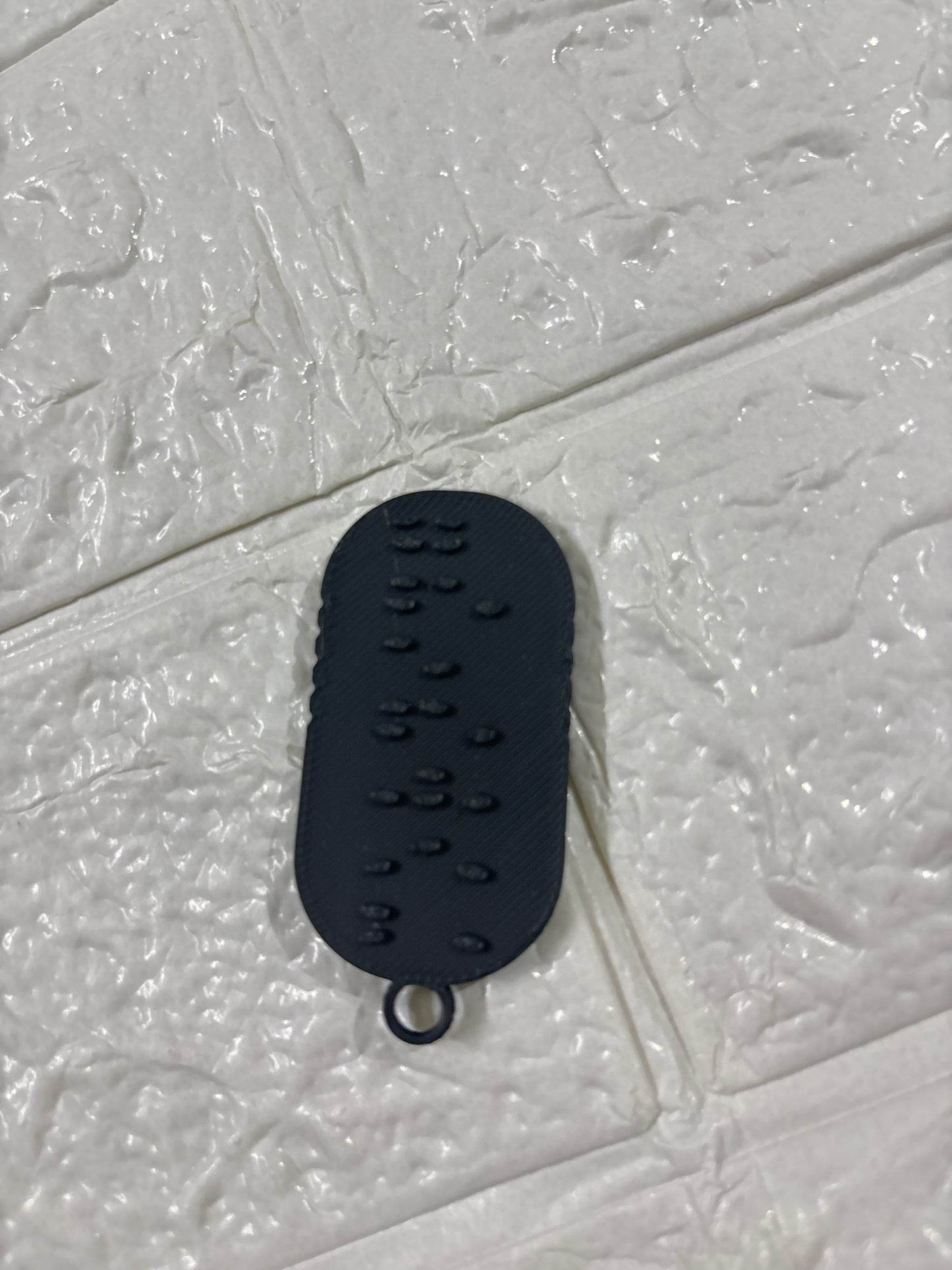 A 3D-printed Braille keychain with a built-in NFC chip — designed for universal accessibility.